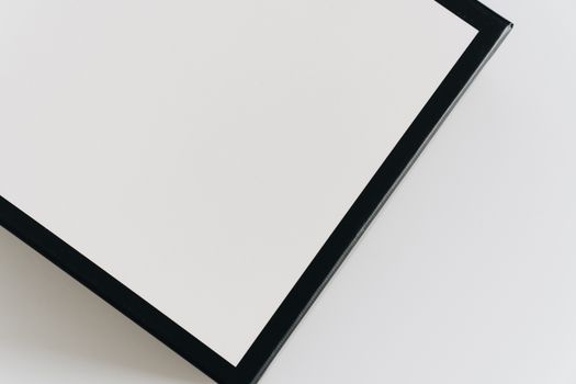 From above closeup of carton square present box with black lines on borders and white center and smooth surface on white background