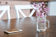 Dining room table with cherry flowers and smartphone