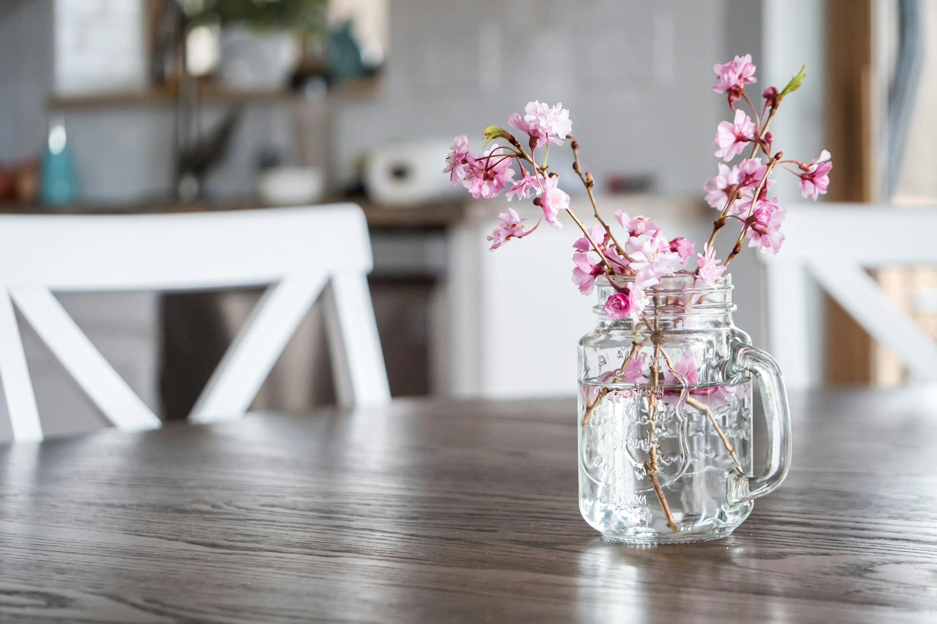 Delicate cherry blossoms in a mason jar adding a fresh spring touch to the kitchen decor.