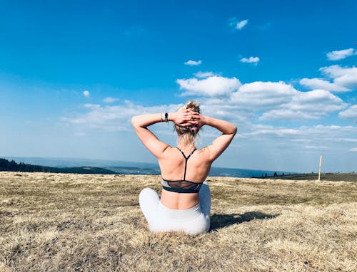 Free stock photo of blonde girl, girl in a sports bra, girl on top of a mountain