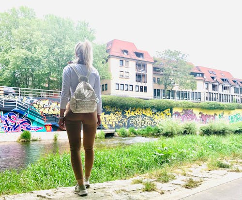 Free stock photo of girl standing, girl with a backpack, grafitti