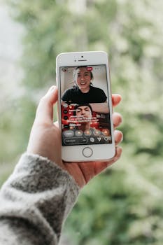Person engaging in a video call on a smartphone in an outdoor setting.