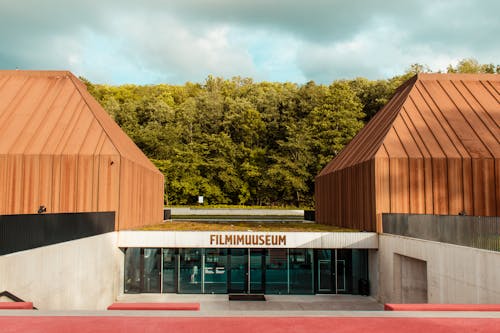 Brown Wooden Building Near Green Trees