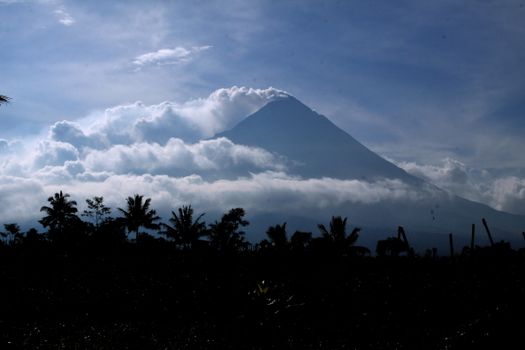 Smoking volcano in tropical countryside