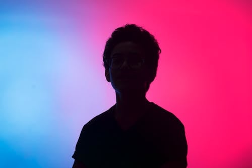 Black silhouette against multicolored background