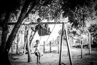 Children on swings in summer garden