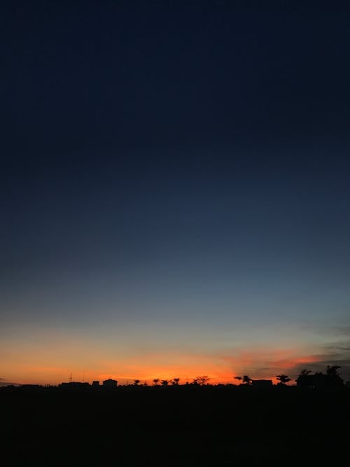 Dark sunset sky above countryside