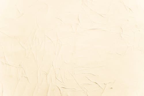 Abstract minimal backdrop with wall decorated with textured stucco in light beige color
