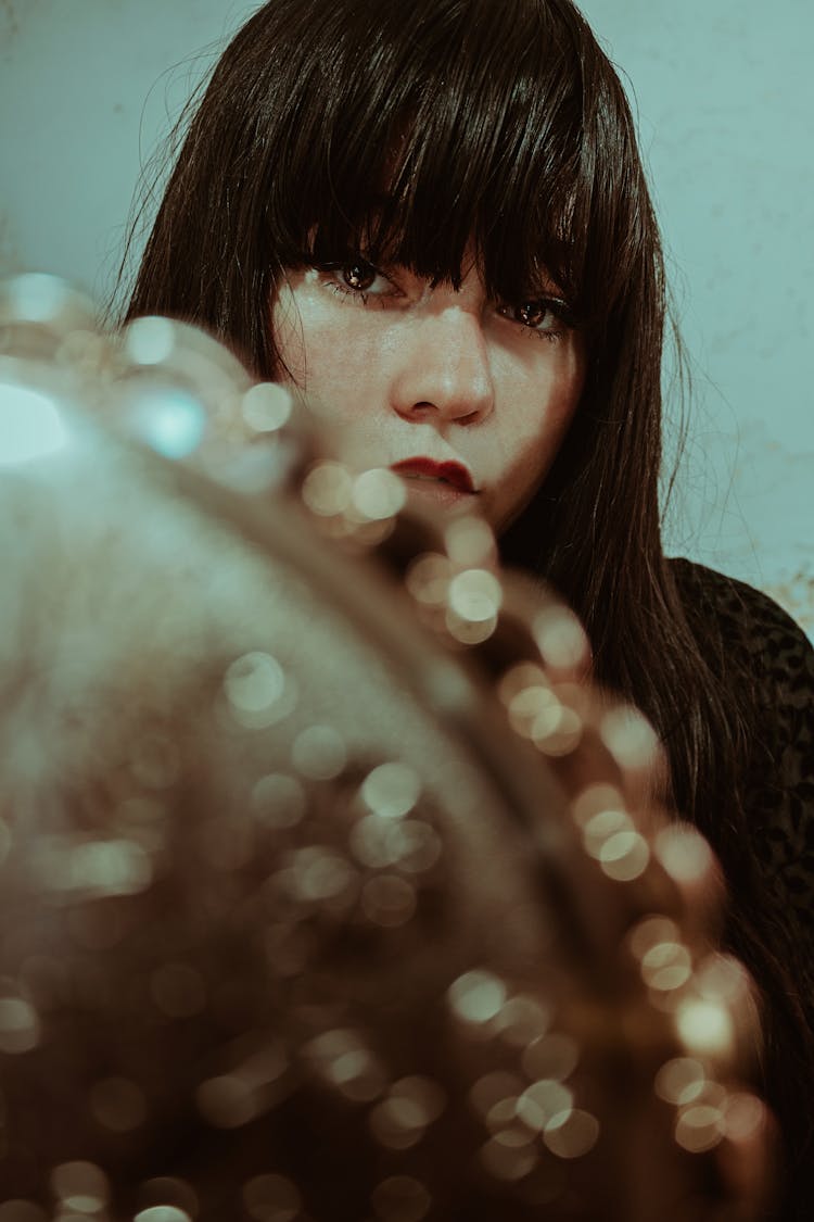 Crop Stylish Ethnic Woman With Makeup In Front Of Mirror