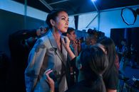 Unrecognizable visagiste applying makeup on face of actress