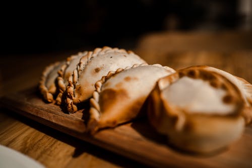 Close-Up Shot of Delicious Empanadas on Wooden Surface