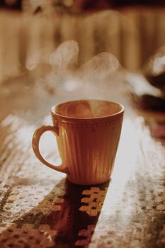 A cozy ceramic mug with steam rising, perfect for hot beverages.