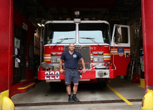 A Man Standing in Front of a Fire Truck