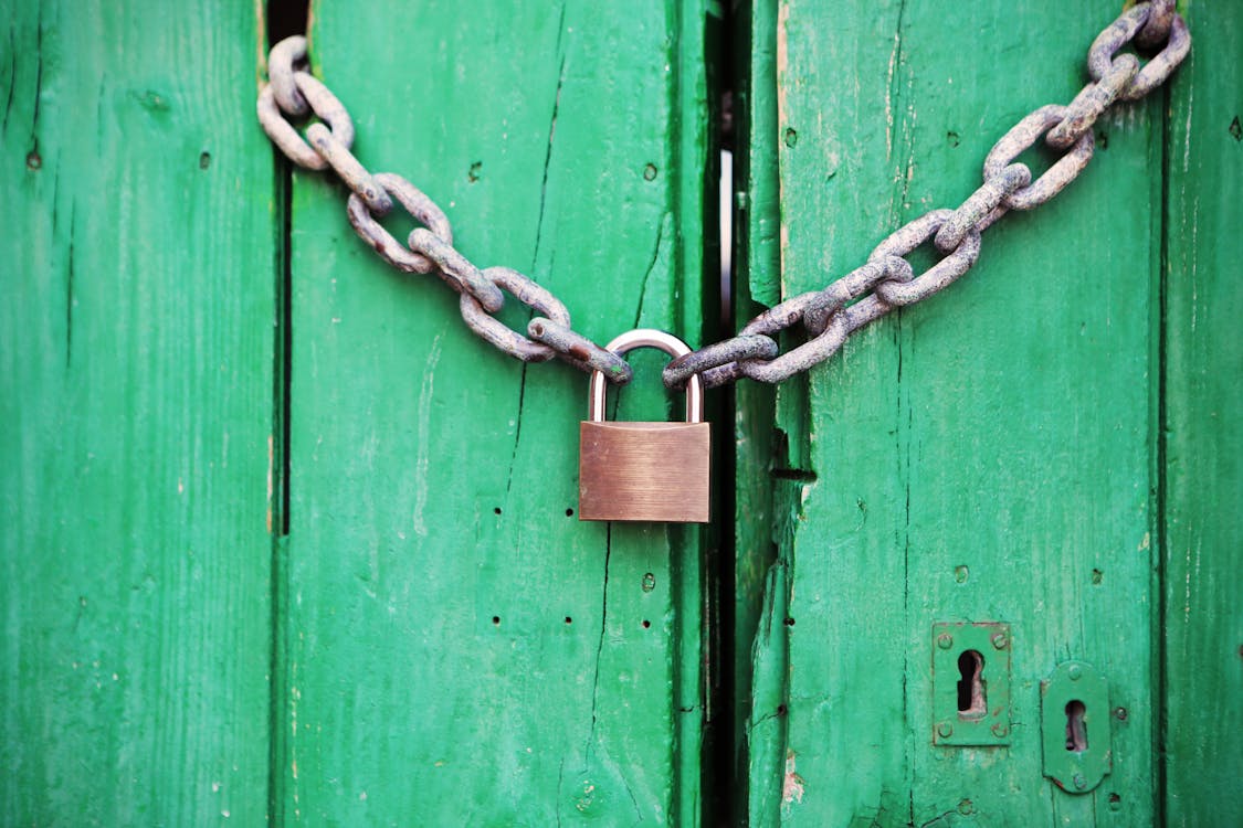 Brass-colored Metal Padlock With Chain