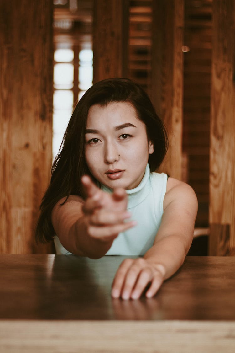 Girl In A Green Turtleneck Reaching For The Camera