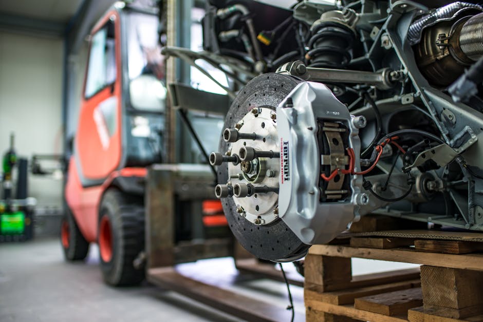 BMW mechanic inspecting brake components - bmw brake pad and rotor replacement cost