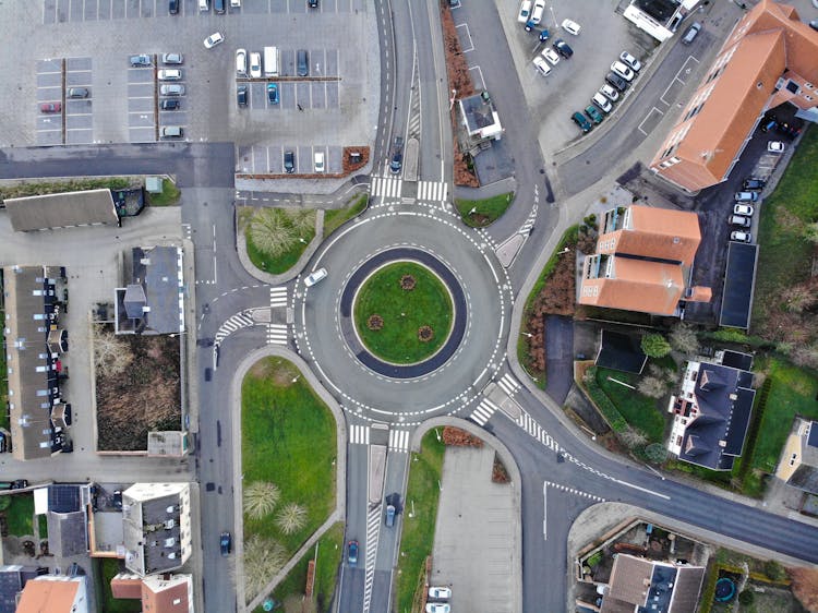 Aerial View Of Suburban Area With Roundabout Intersection