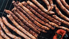 Aromatic roasting sausages on barbecue grid