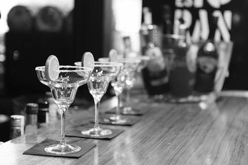 Grayscale Photography of Margarita Glass on Table
