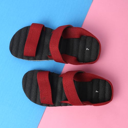 Free Stylish red sandals displayed on a vibrant blue and pink background, perfect for summer fashion. Stock Photo