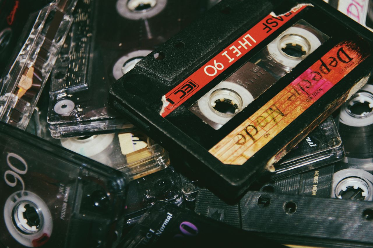 high angle heap of retro audio cassette tapes collection scattered on