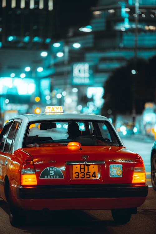 Free Selective Focus Photo of a White and Red Taxi Stock Photo