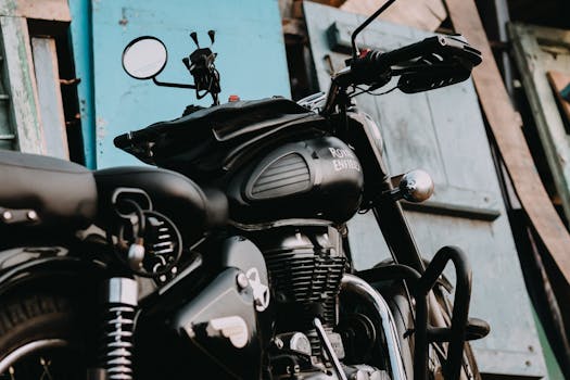 Close-up of a classic Royal Enfield motorcycle parked outdoors in Coimbatore, India.