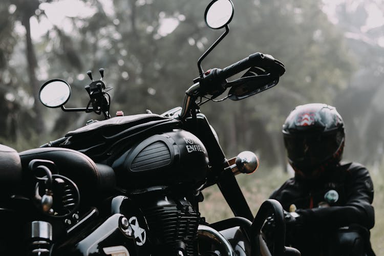 Man In Black Helmet Looking At The Motorcycle