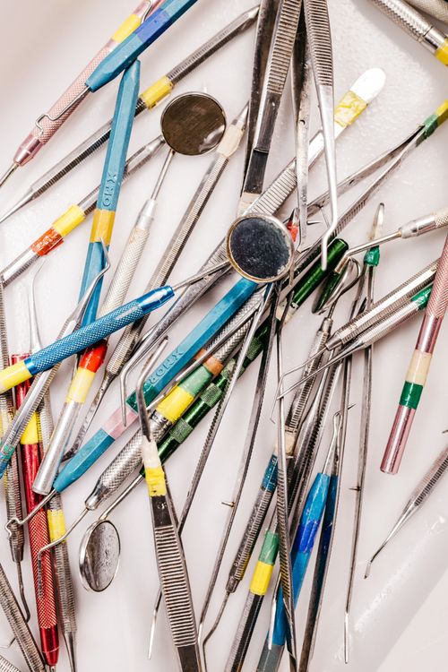 Free A variety of colorful dental tools including mouth mirrors and tweezers arranged closely. Stock Photo