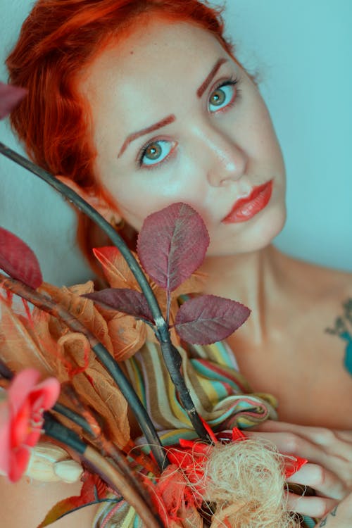 Woman Holding a Branch of Leaves