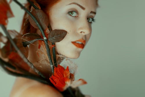 Woman Holding Flowers Near Her Face