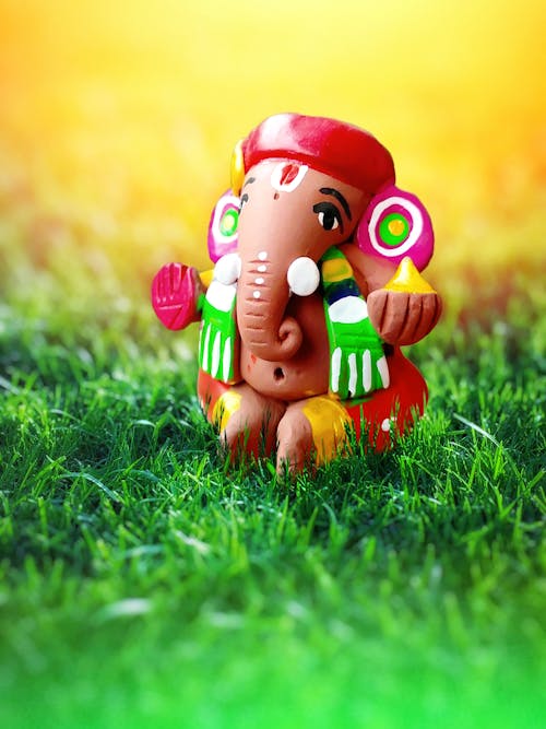 Free Colored Elephant Toy on Green Grass Stock Photo
