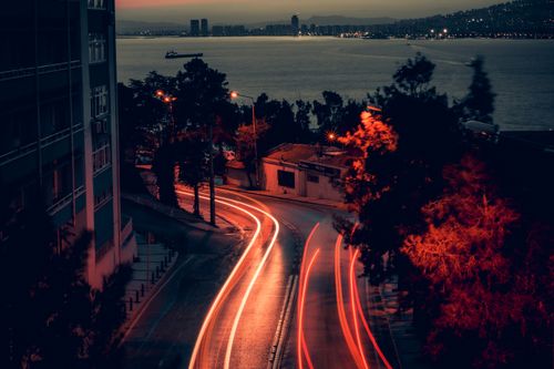 Free A stunning night aerial shot of İzmir's waterfront with light trails and city lights. Stock Photo