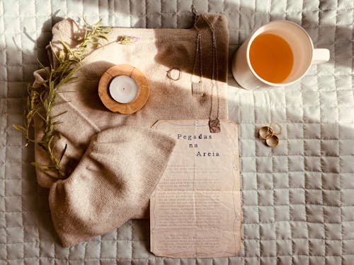 Candle, Tea, Book Page and Jewelry Still Life