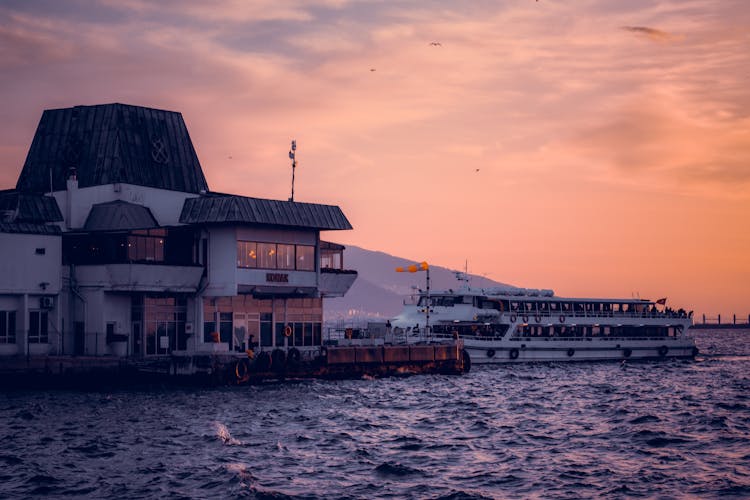 Docked Ferry Near A Building 