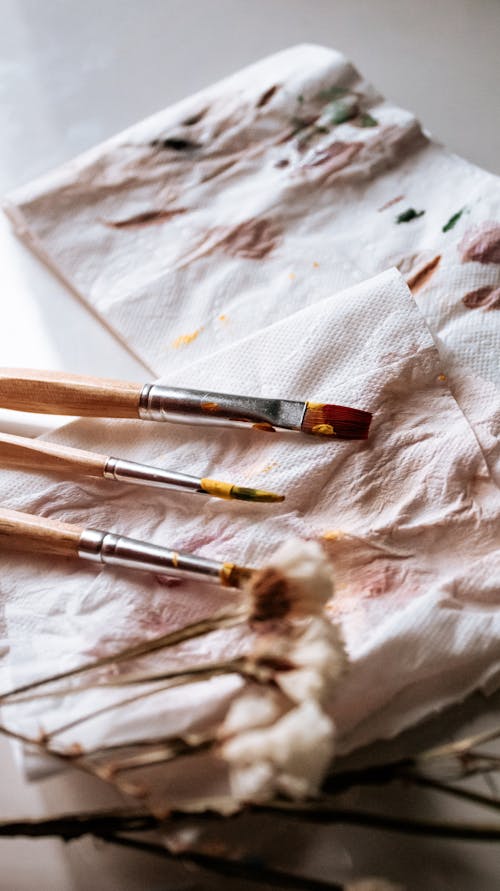 Paint Brushes on White Paper Napkins