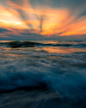 Captivating sunset over a turbulent sea with vibrant colors and dramatic skies.