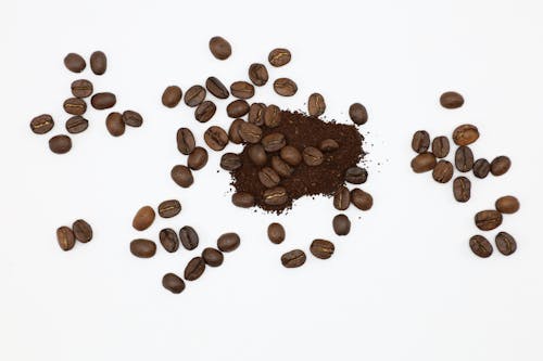 Close-Up Shot of Roasted Coffee Beans on White Surface