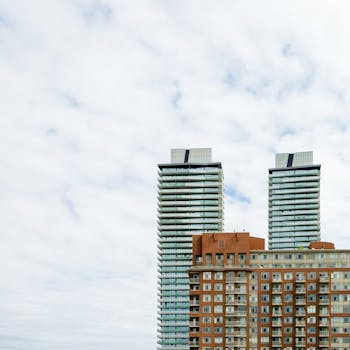 High-rise buildings dominate the cityscape under a cloudy sky, showcasing urban architecture.
