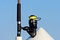 Fishing rod with line placed in boat