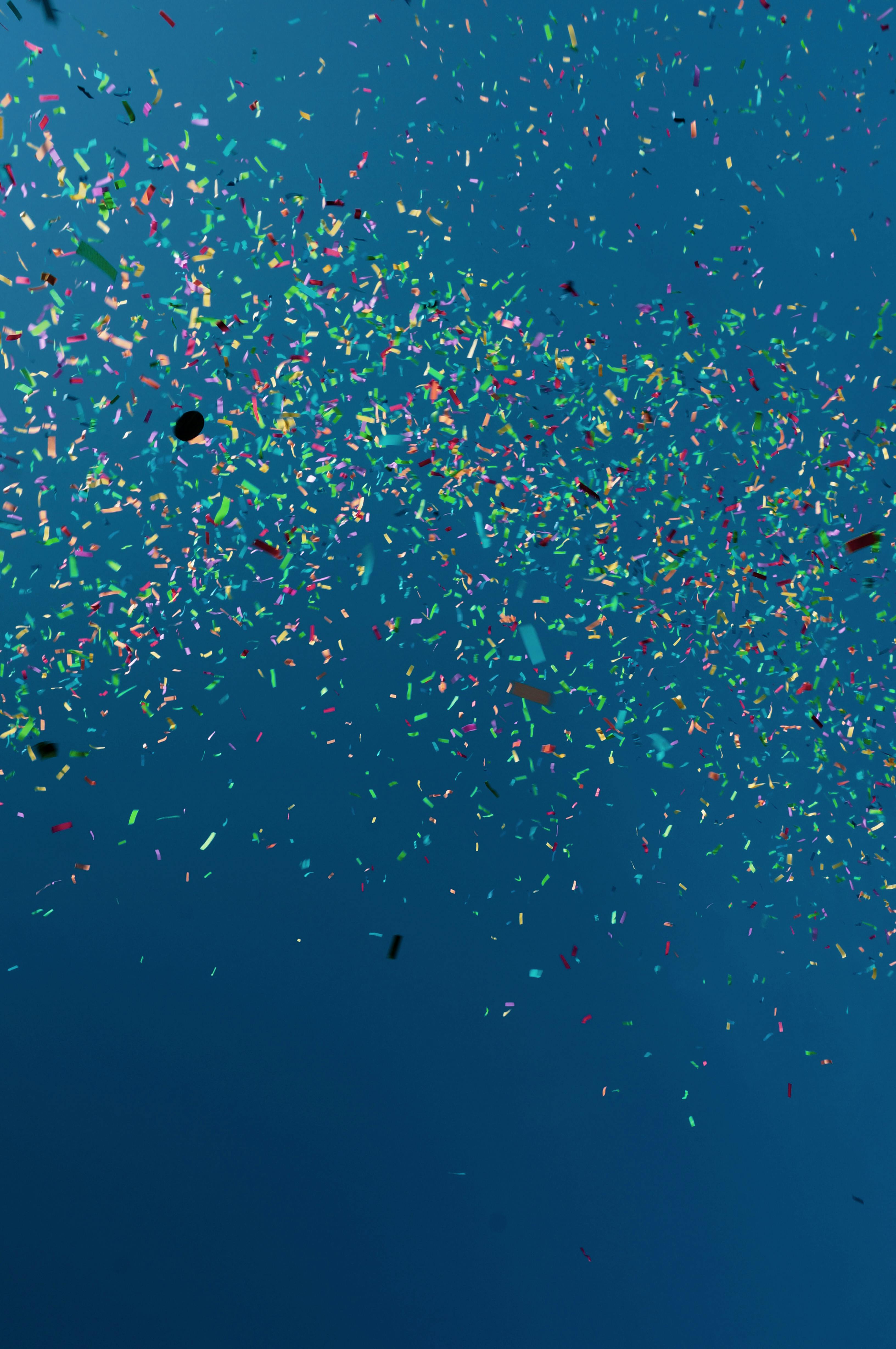 Bright colorful confetti in blue water · Free Stock Photo
