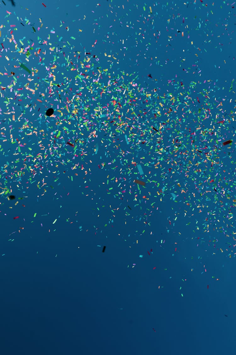 Bright Colorful Confetti In Blue Water