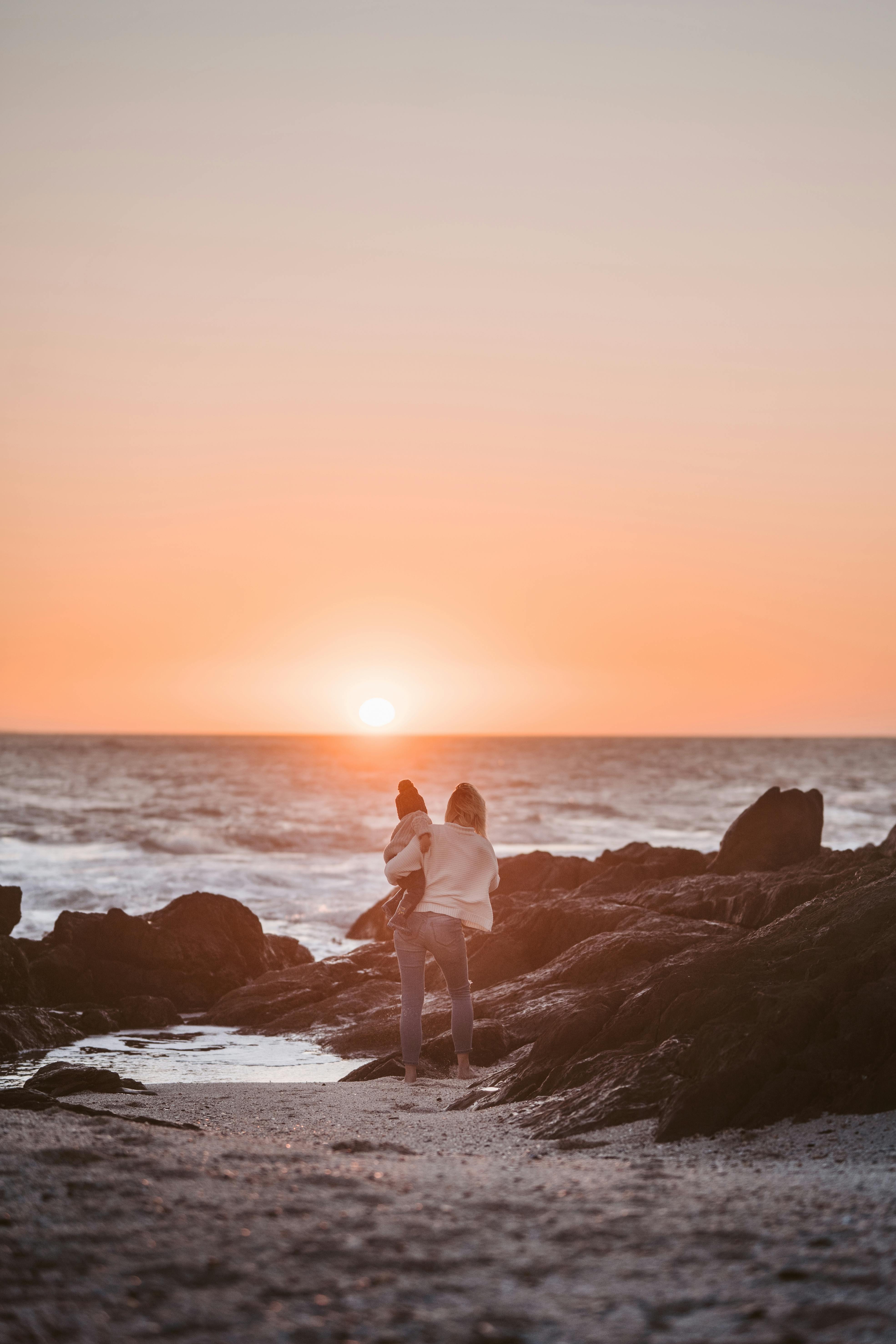 a mother and child at the beach