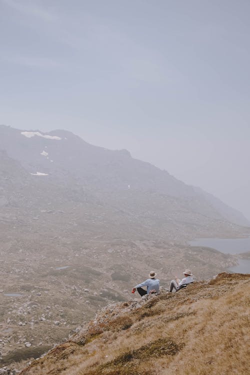 People Sitting on Top of a Mountain