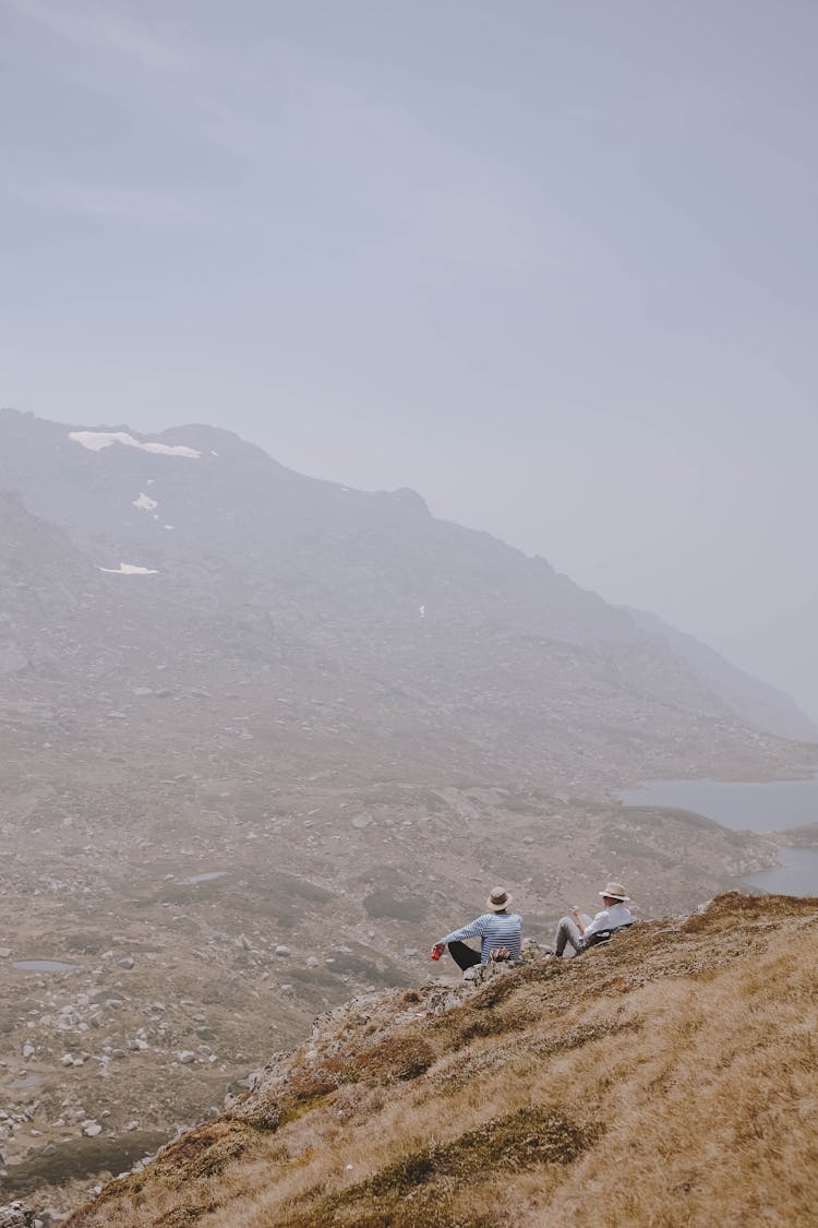 People Sitting On Top Of A Mountain