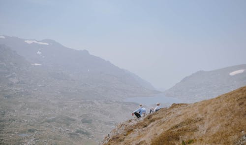 People Sitting on Top of a Mountain