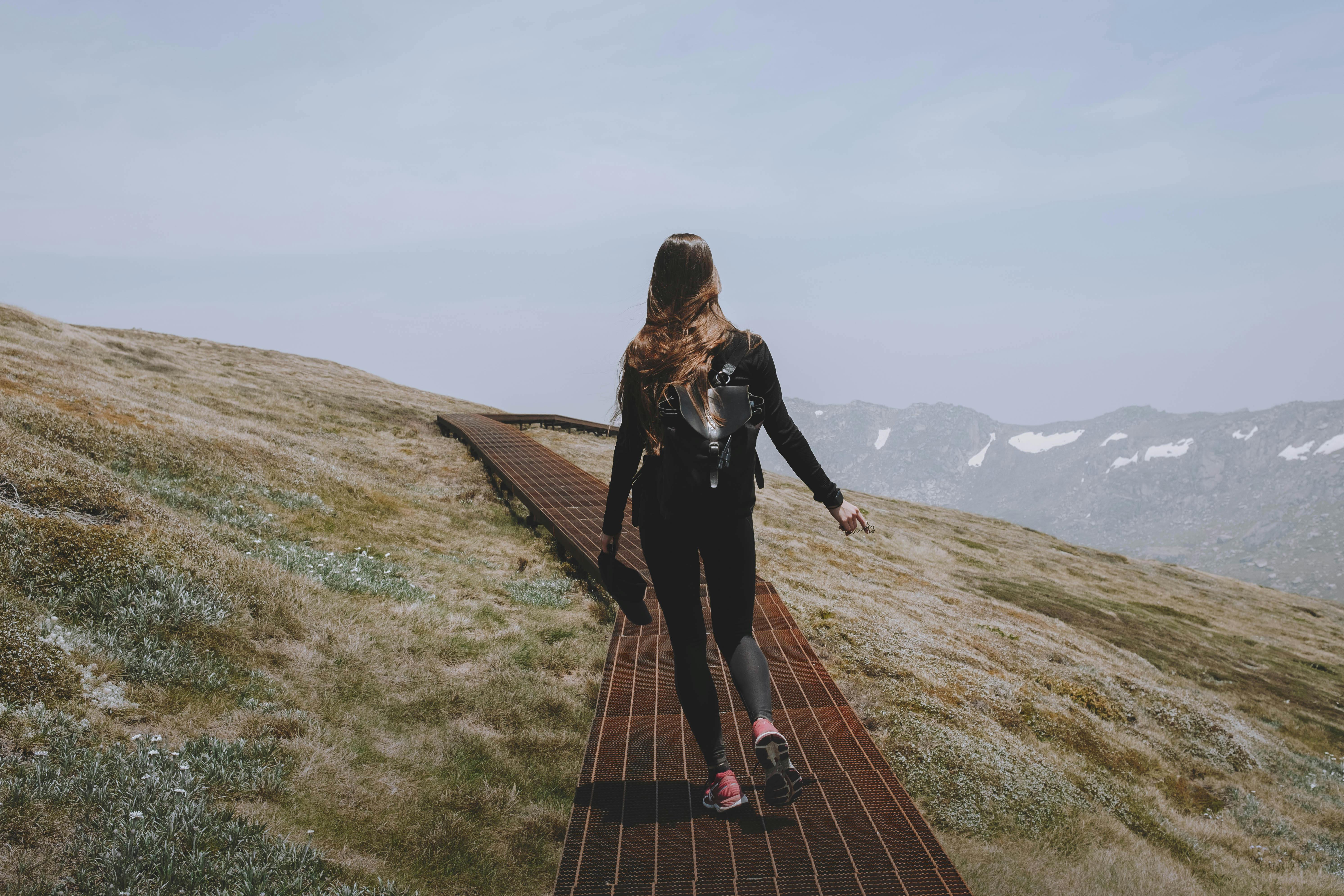 a woman hiking on a mountain