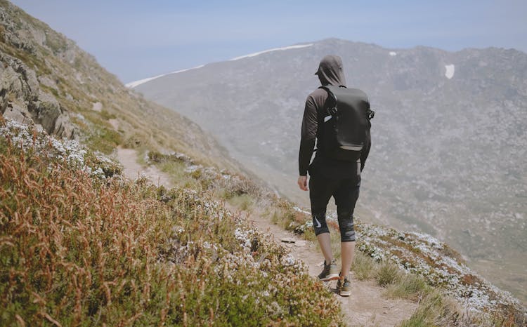 A Man Hiking On A Mountain