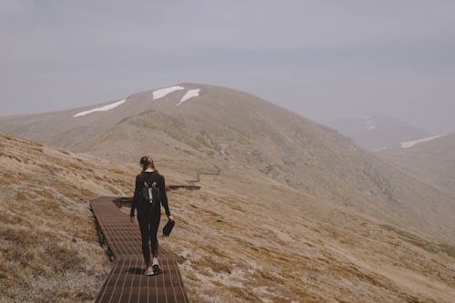 A Woman Hiking on a Mountain