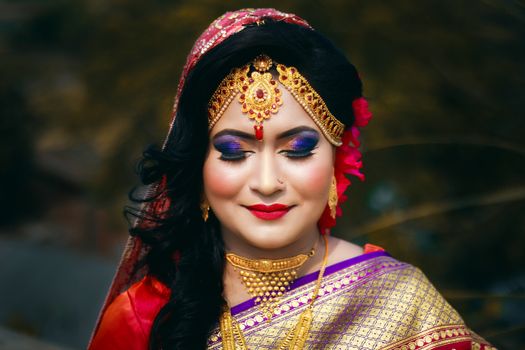 Captivating portrait of a South Asian bride with detailed jewelry and traditional attire, exuding elegance and beauty.